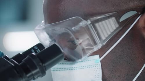 African American Scientist Using Microscope