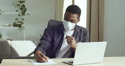 Person with Face Mask Working at Home Office