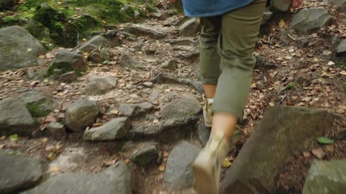 A Female Tourist Is Walking Along a Stony Path, Closeup Legs