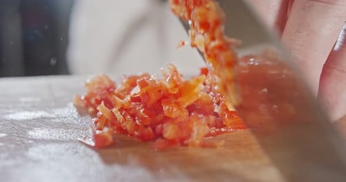 Chef Dicing Fresh Tomatoes on Cutting Board