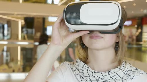 Young Woman Uses Virtual Reality Headset in Public