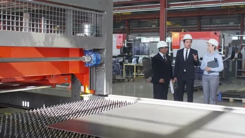 Engineer Telling Partners about Manufacturing Process on Factory