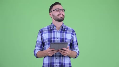 Man Using Tablet Against Green Background