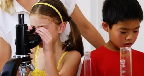 Children Learning Science in Classroom with Microscope