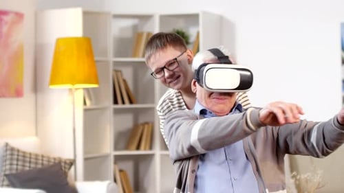 Senior Man Laughing While Wearing VR Headset