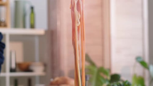 Male Cook Using Tongs while Preparing Spaghetti
