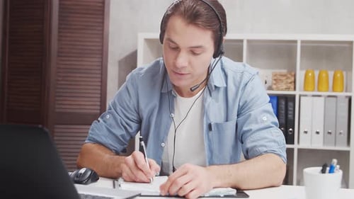 Workplace of freelance worker at home office. Young man works using computer.