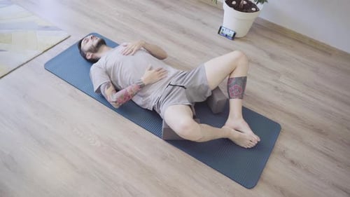 Man Lying on Yoga Mat Resting
