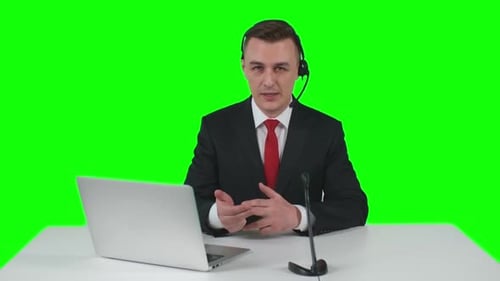 Professional Man Speaking Into Headset on Green Screen