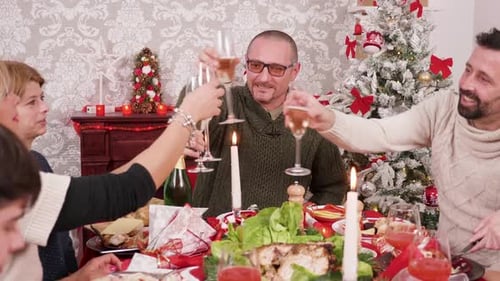 Family Celebrates Christmas with Toast and Feast
