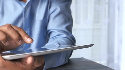 Man's Hand Working on Digital Tablet at Office Desk, Using Self Created Chart
