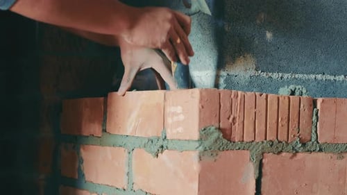 Builder Lays Bricks Close Up