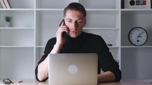 Portrait of Confident Businessman Talking on Mobile Phone in Modern Office