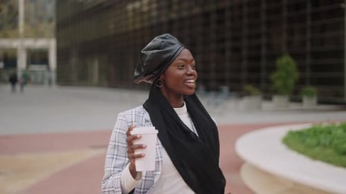 Woman Walking Confidently Through Urban Environment