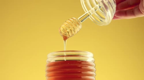 Closeup of Honey Spoon with Pouring Honey