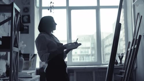 Beautiful Female Painter Drawing Picture in Art Studio