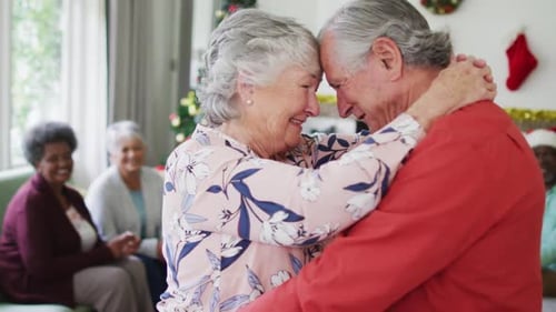 Senior Couple Dances Together at Christmas Celebration