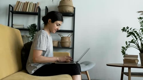 Woman Working on Laptop at Home