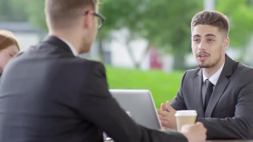 Two Business Colleagues Talking in Cafe
