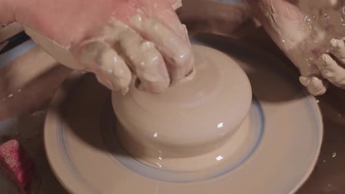 Hands Shaping Clay on Pottery Wheel Close Up