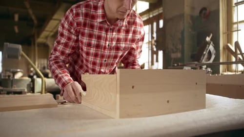Carpenter Constructing Wooden Box in Woodshop