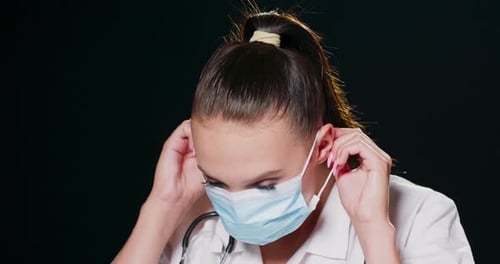 Medical Worker Putting on Surgical Mask, Close Up