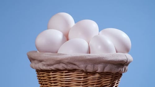 White Eggs Fill a Wicker Basket Close Up