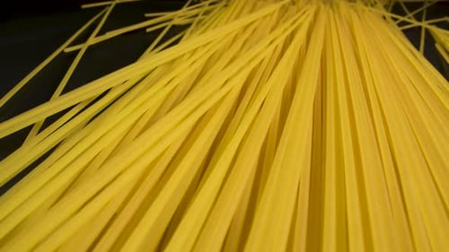 Close-up of uncooked spaghetti strands.