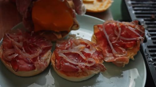 Delicious Burgers Being Assembled with Cheese and Meat