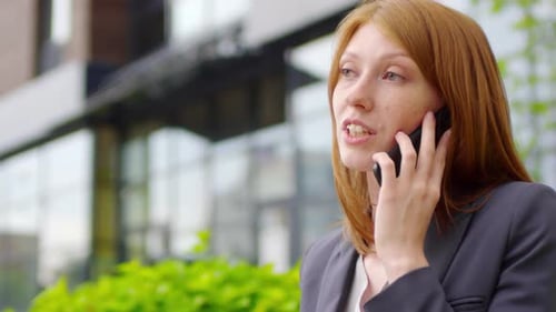 Woman Having Phone Conversation Outdoors