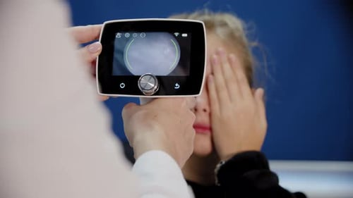 Child Receives Eye Exam with Digital Medical Device