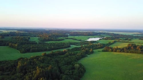 Aerial View of Countryside Fields and Lake at Sunrise