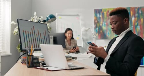 Office Workers Sit at Their Desks in Front of Computer Monitors Not Attending to Their Duties Using