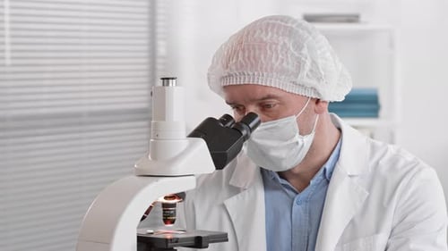 Lab Assistant Using Microscope