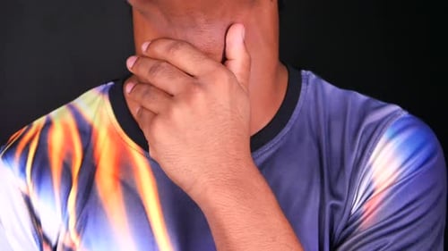 Hand Gripping Neck in Close Up on Black