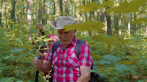 Active Senior Couple Hiking Through Forest
