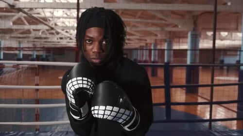 Concentrated African Boxer Training at Ring Front View
