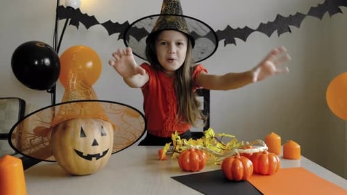 Girl in Witch Costume Makes Scary Face for Halloween