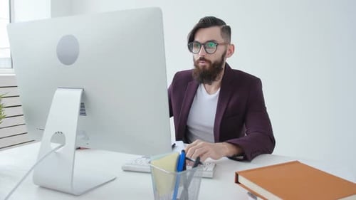 Concept of Freelancing and Office Work. Young Male Office Worker in the Workplace