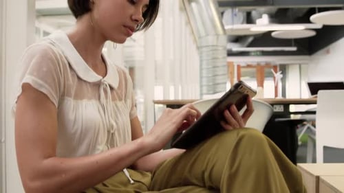 Businesswoman using digital tablet in modern office