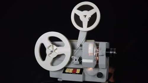 Vintage Film Projector Reel Rotating on Black Background