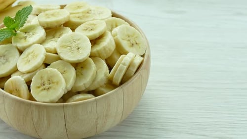 Sliced Bananas in Wooden Bowl Close-Up