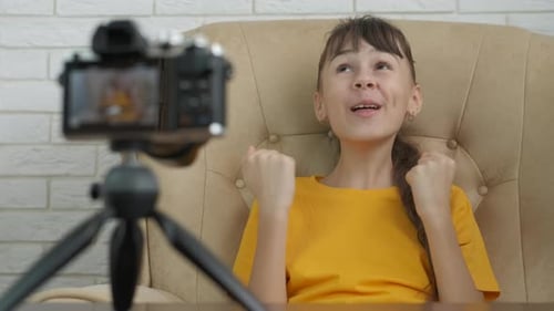 Young Girl Vlogging with Camera at Home