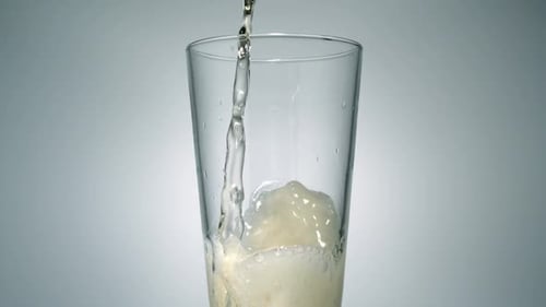 Liquid Being Poured Into a Glass Cup