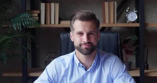 Smiling Man with Beard at Desk