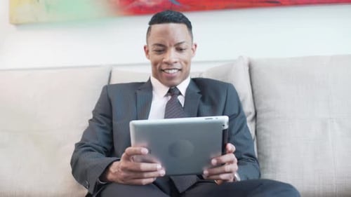 Mid adult man using digital tablet