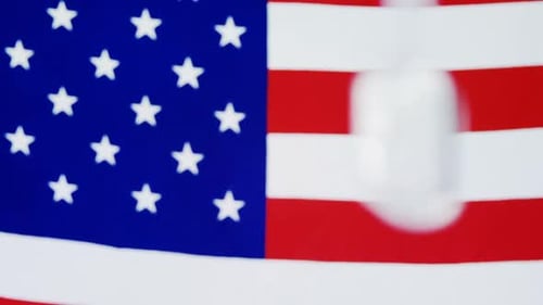 Military Dog Tags Against American Flag Backdrop