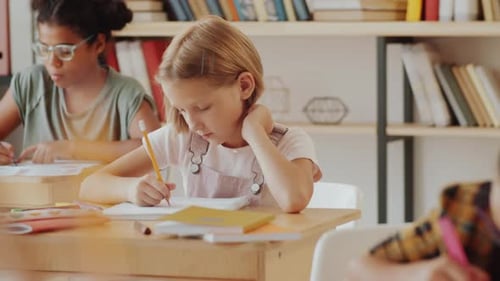 Children Focused on Schoolwork in Classroom Setting
