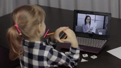 Young Girl Learning Online with Laptop at Home