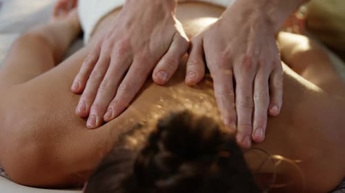 Woman Receives Back Massage at Health Spa